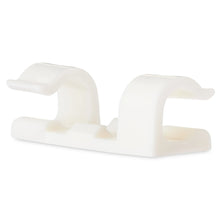 Pair of white adhesive cable management clips in close-up view.