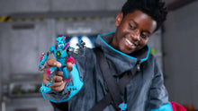 Panther-themed blue action figure held by a person wearing a dark jacket