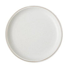White dinner plate close-up with thin gold rim and speckle glaze