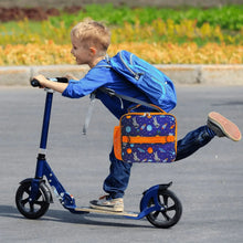 Insulated kids lunch bag with purple space print and orange trim, worn on a kick scooter