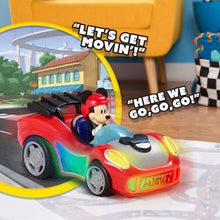 Red and white toy car with Mickey in blue seat, bright front headlights glowing