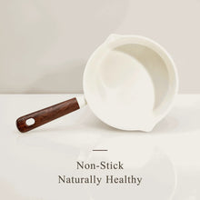 White ceramic nonstick saucepan with wooden-style handle, open interior
