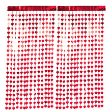 Red foil heart photo backdrop with hanging heart string curtain