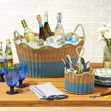 Two-tone rattan drink basket holding assorted bottles and glasses, blue-and-tan weave