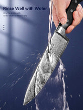 Kitchen knife with water rinse spray splashing off blade