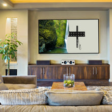 Fixed TV wall mount bracket on the wall holding a flat-screen TV