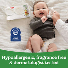 Baby wipes soft pack and infant on bed with white wipes