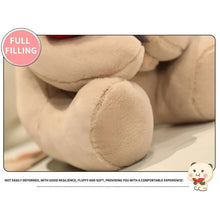 Cream teddy bear plush leg and paw close-up with red rose and gray bow