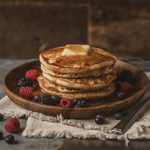 Stack of buttermilk pancakes with berries on a plate