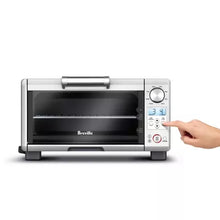 Mini toaster oven with lit display and hand turning side control knob