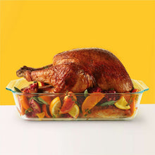 Rectangular glass baking dish with roasted chicken and citrus vegetable pieces
