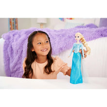 Singing Elsa doll with long blonde braid and light blue glitter dress, full-body view
