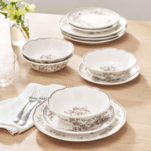 Stoneware dinnerware set on table: matching floral bowls and plates in white