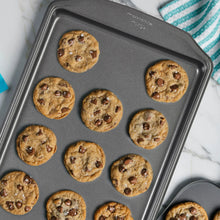 Rectangular non-stick baking sheet with baked chocolate chip cookies