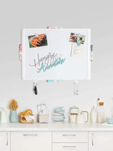 Dry erase whiteboard with plastic frame, notes and magnets displayed on surface