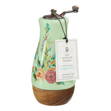 Ceramic pepper mill with painted meadow florals, metal grinder, acacia wood base; tag attached