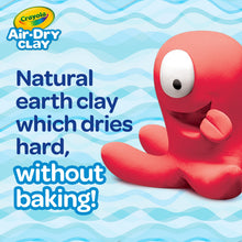 Air-dry clay creature shaped like a smiling red figure with white eye