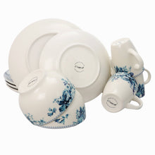 Ceramic dinnerware set with blue rose accents and visible plate and cup bottoms
