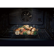 Rectangular glass bake dish in oven, chicken with herbs