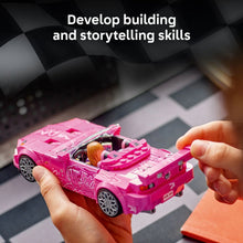 Pink LEGO Speed Champions race car toy being assembled with hands
