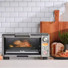 Countertop toaster oven with food baking and front temperature dial
