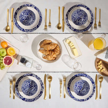 Blue and white ceramic plates and bowls with gold-toned forks and knives