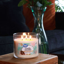 Great Value coastal coconut scented candle burning in clear glass jar