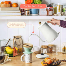 White electric kettle pouring stream from gold gooseneck spout