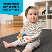 Infant playing with musical take-along toy with colorful bead chaser and lit screen