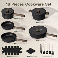 Black nonstick pots and pans set with several pieces arranged, including frying pans
