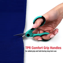 Teal and black comfort-grip scissors held in hand, pointed blades visible.