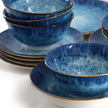 Close-up of blue porcelain bowls with gold rim in matching stack