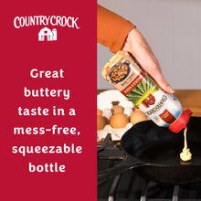Country Crock drizzle & sizzle squeeze bottle held in hand, red cap