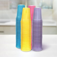 Stack of translucent plastic party cups in blue, yellow, pink, and purple