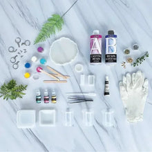 Epoxy resin craft kit contents with resin bottles, molds, pigments and mixing sticks