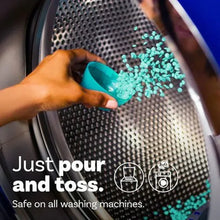 In-wash scent beads being poured into a washing machine drum