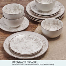 Stoneware dinnerware set with floral bowls and layered dinner plates on wood table