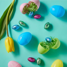 Milk chocolate Easter candy eggs and foil-wrapped pieces with blue and green egg shapes