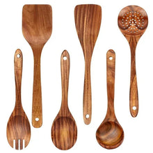 Teak wooden cooking utensil set with multiple spoons and spatulas, natural finish