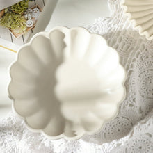 White scalloped decorative bowl with leaf-like ridged rim