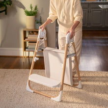 2-in-1 step stool with white platform and wooden frame, front view on carpet