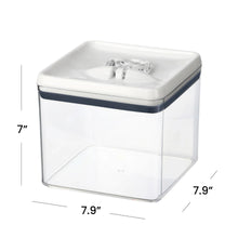 Airtight bagel food storage container with clear sides, white flip lid, and dark blue band
