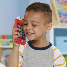 Red Elmo learning phone held up, showing white eyes and orange nose