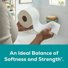 Toilet paper roll with sheet, held in hands above a bathroom counter