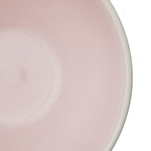Blush stoneware plate close-up, glossy glaze and smooth rim