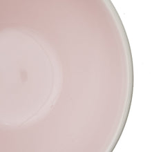 Blush stoneware plate rim with glossy glaze, close-up