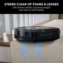 Robot vacuum on carpet near stairs and ledges, front top view