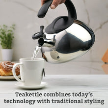Silver stainless steel whistling tea kettle pouring hot water, black handle and spout