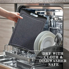 Dark grey cutting board placed in dishwasher rack, with hanging hole.