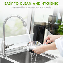 Stainless steel juicer extractor with spout and cleaning hands over sink